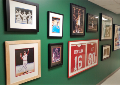 Gallery wall of framed sports memorabilia