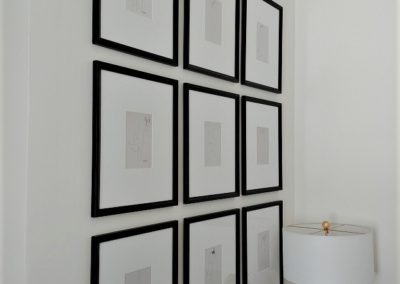 Wall of framed prints in Los Feliz home