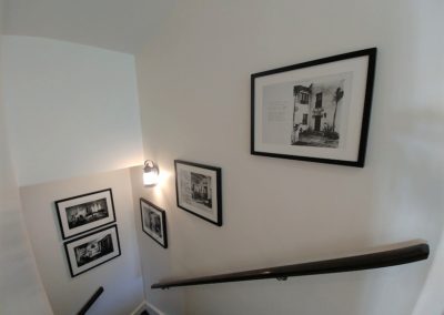 Framed prints in stairwell of Los Feliz home