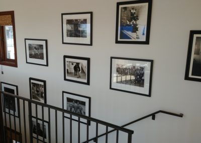 Framed photos in stairwell of Hermosa Beach home