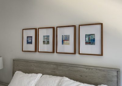 Wall of prints in Manhattan Beach guestroom